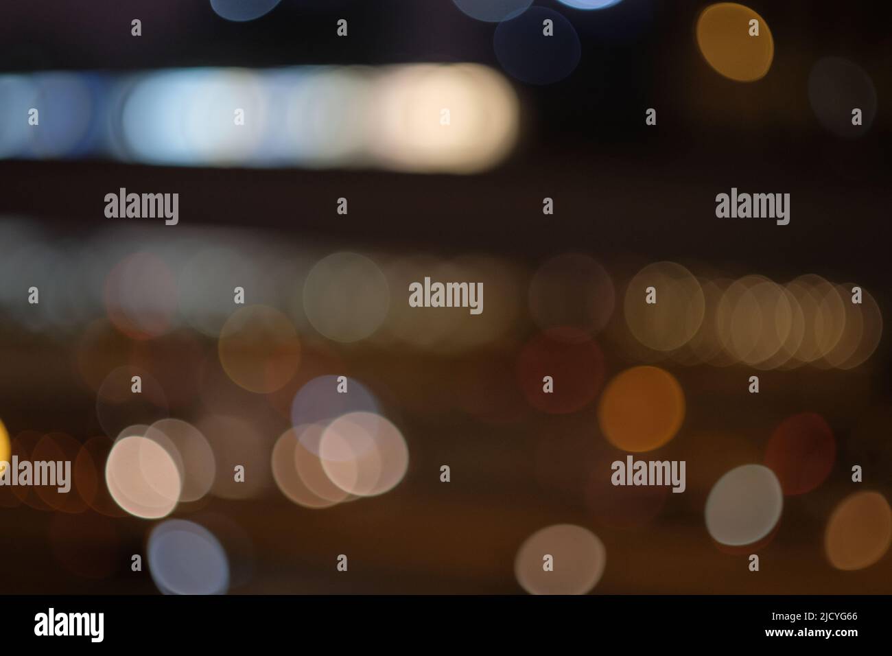 Blurry city lights at night for a dreamy aesthetic. Abstract conceptual shot of getting lost in thought or losing perspective. Horizontal copy space. Stock Photo