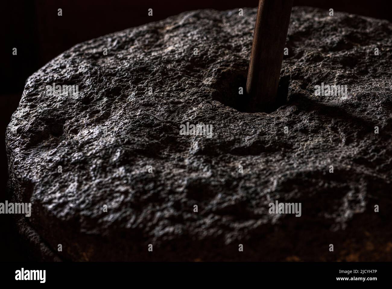 Detail of a millstone used for grinding corn at the Eco Museum showing artifacts and displays of the agricultural and rural lifestyle of the local peo Stock Photo