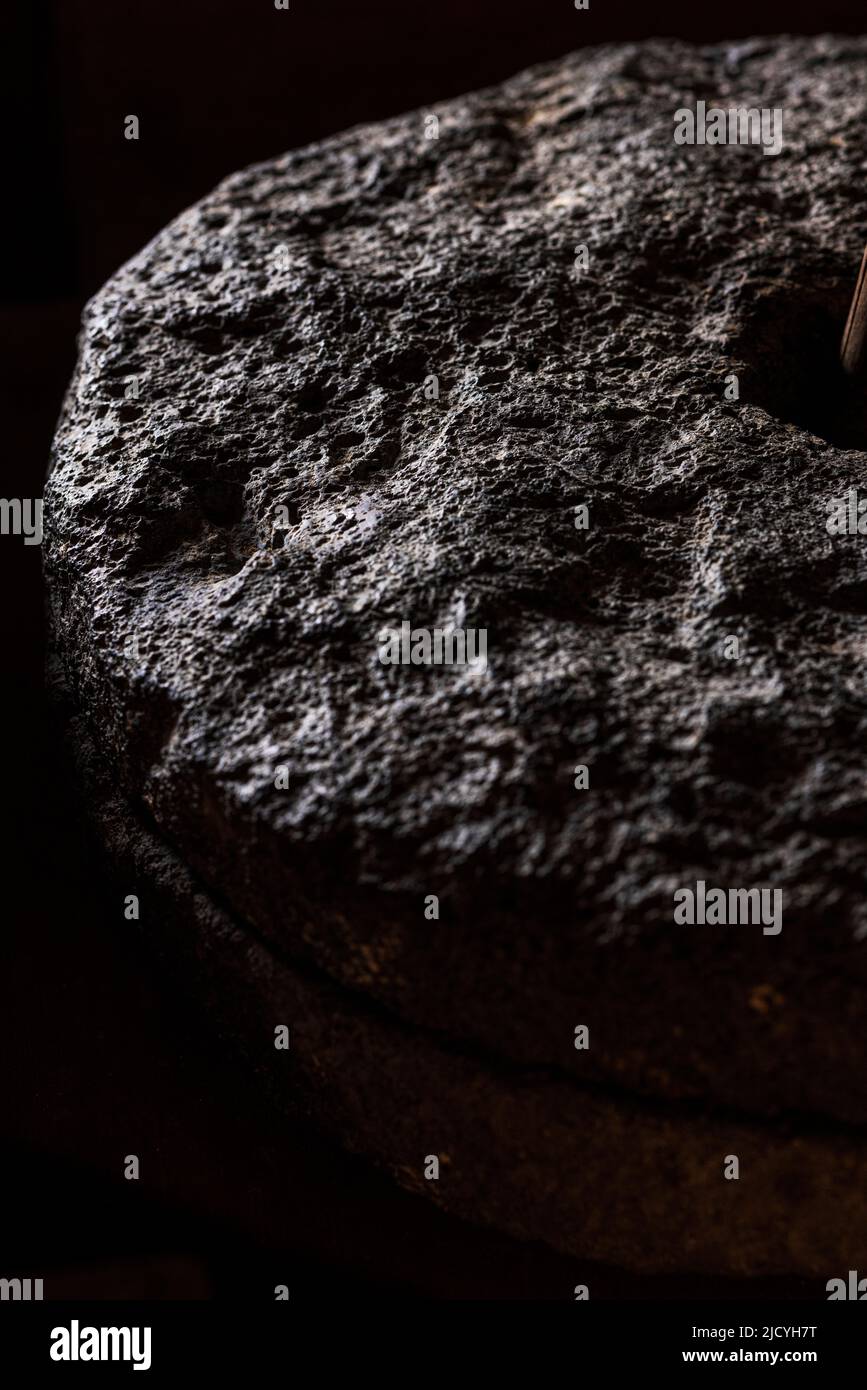 Detail of a millstone used for grinding corn at the Eco Museum showing artifacts and displays of the agricultural and rural lifestyle of the local peo Stock Photo
