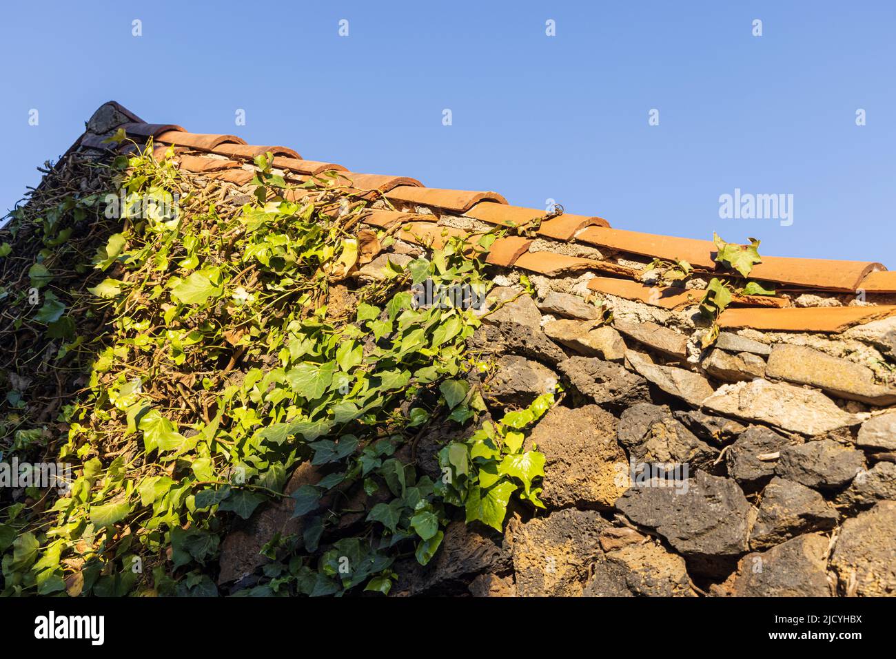 Roof detail with red tiles and stone walls, Rural hotel, Caserio Los Partidos, El Tanque, near Santiago del Teide in Tenerife, Canary Islands, Spain Stock Photo