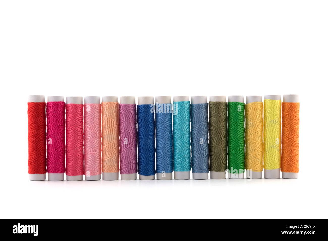 Colourful thread spools on white background with clipping path Stock Photo