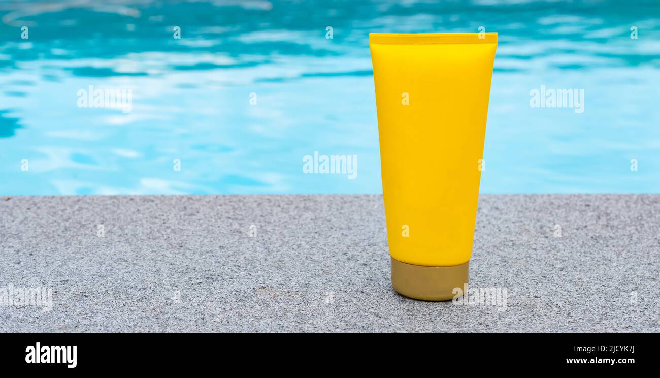 Sunscreen at the swimming pool. Mock-up. Stock Photo