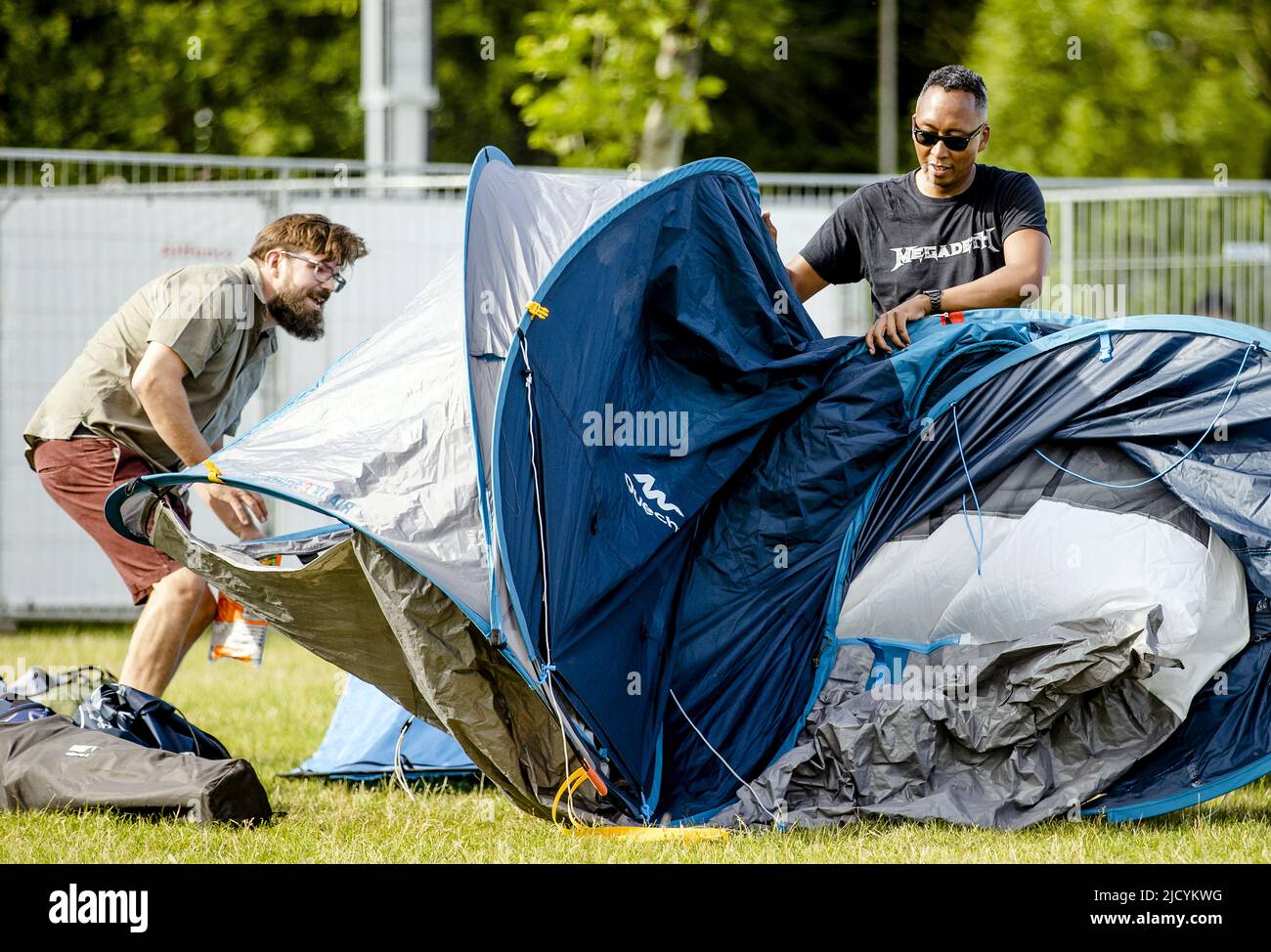 2022-06-16 18:16:32 LANDGRAAF - The first Pinkpop camping guests build a  tent at the camping site. After a two-year delay due to the corona crisis,  the 51st edition of Pinkpop will start