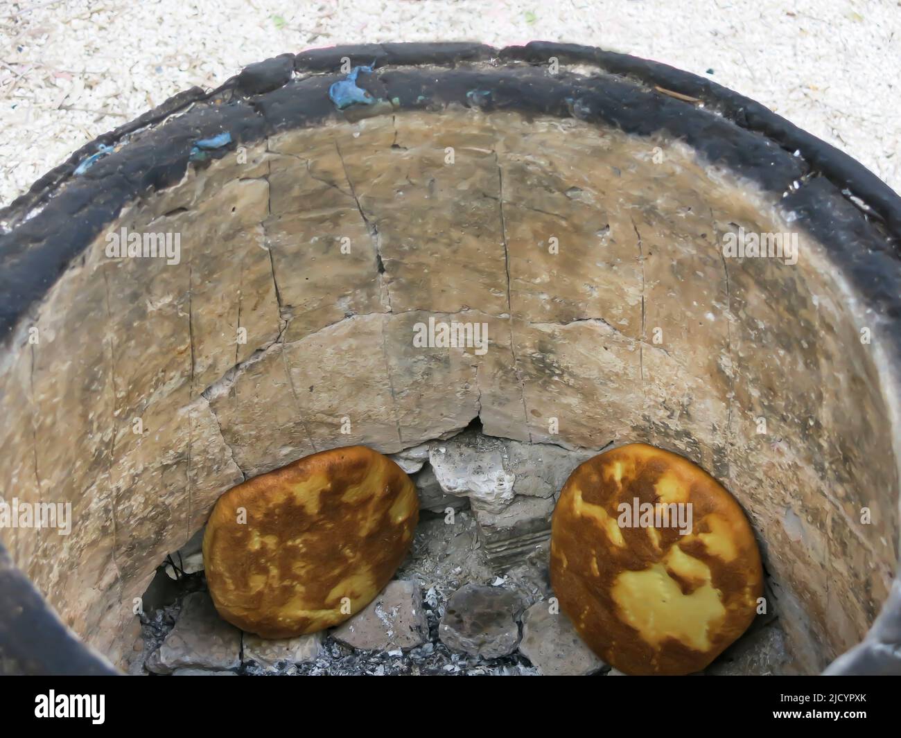 Cooking Tabouns Bread in Roadside Oven Stock Photo