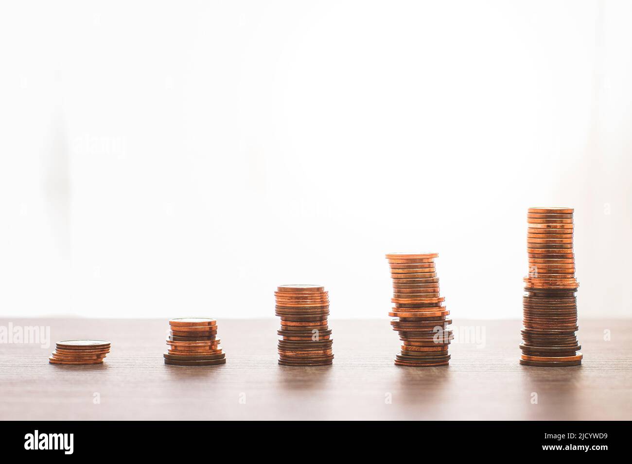 Several stacks of 1, 2 and 5 cent coins symbolizing the bars of an upward trending graph. Stock Photo