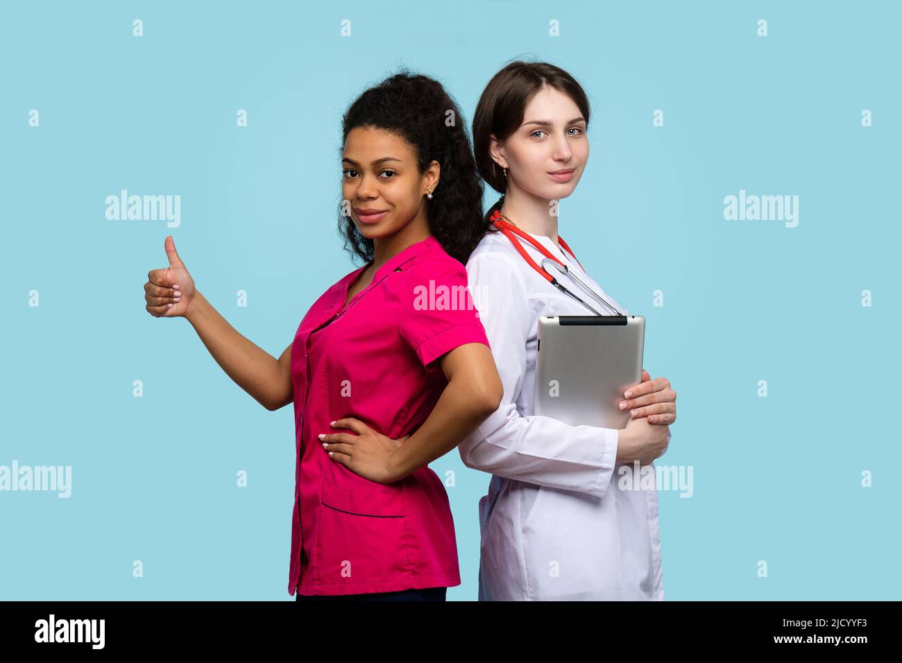 Caucasian Woman GP with Digital Tablet and Dark Skinned Female Doctor ...