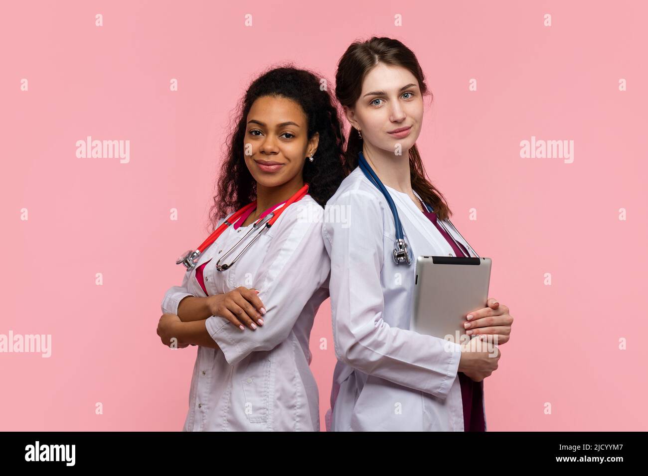 Portrait Two Female Doctors GP with Arms Crossed on Chest and Digital