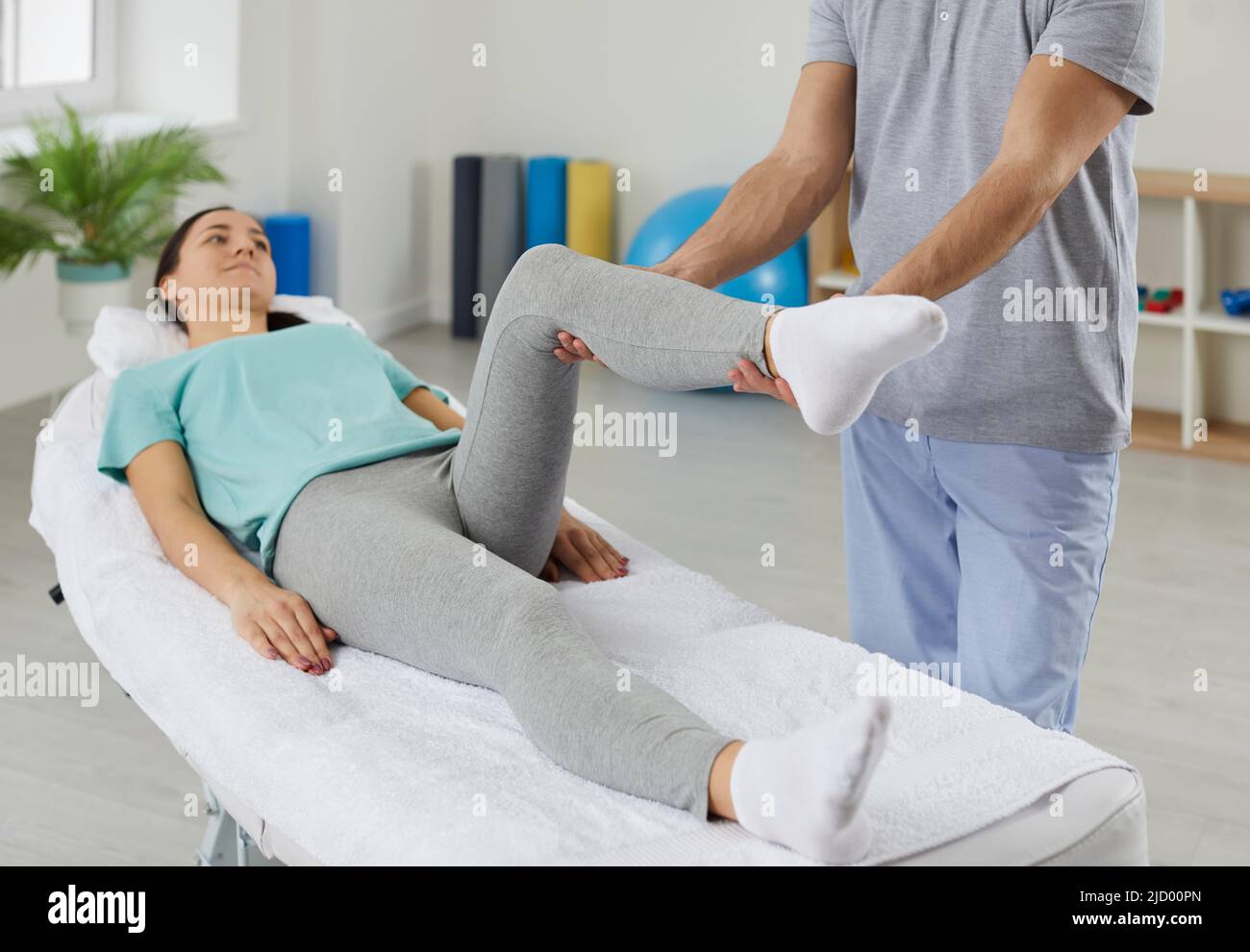 Physiotherapist help female patient with leg recovery Stock Photo Alamy
