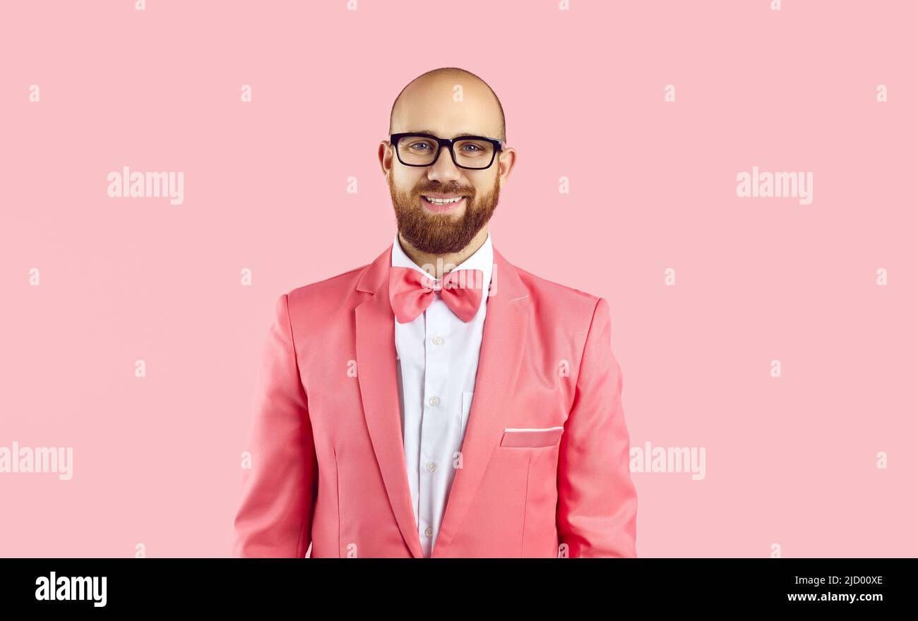 Portrait of smiling man in suit isolated on pink background Stock Photo