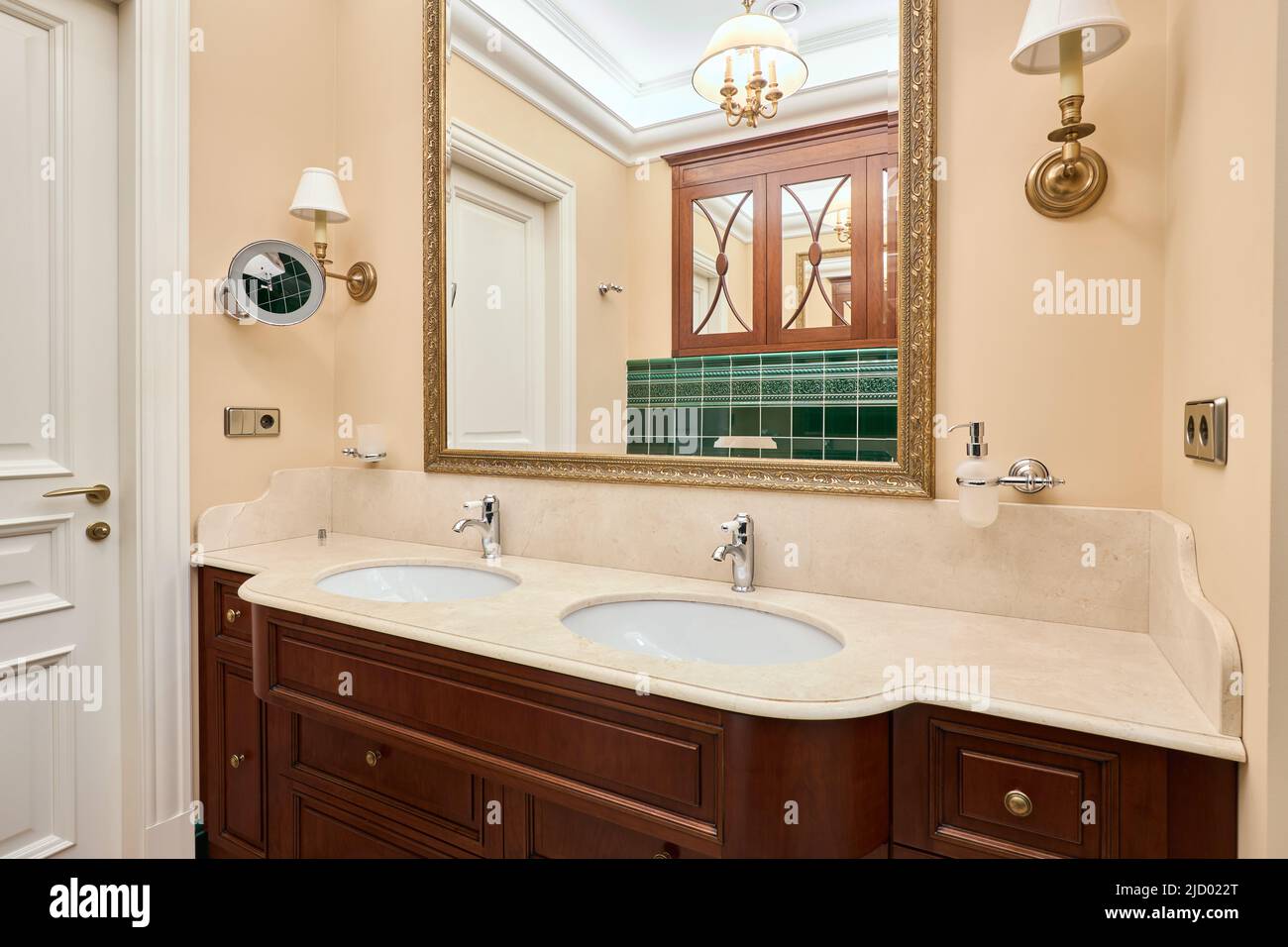 Beautiful cozy luxury bathroom with green tiles Stock Photo - Alamy