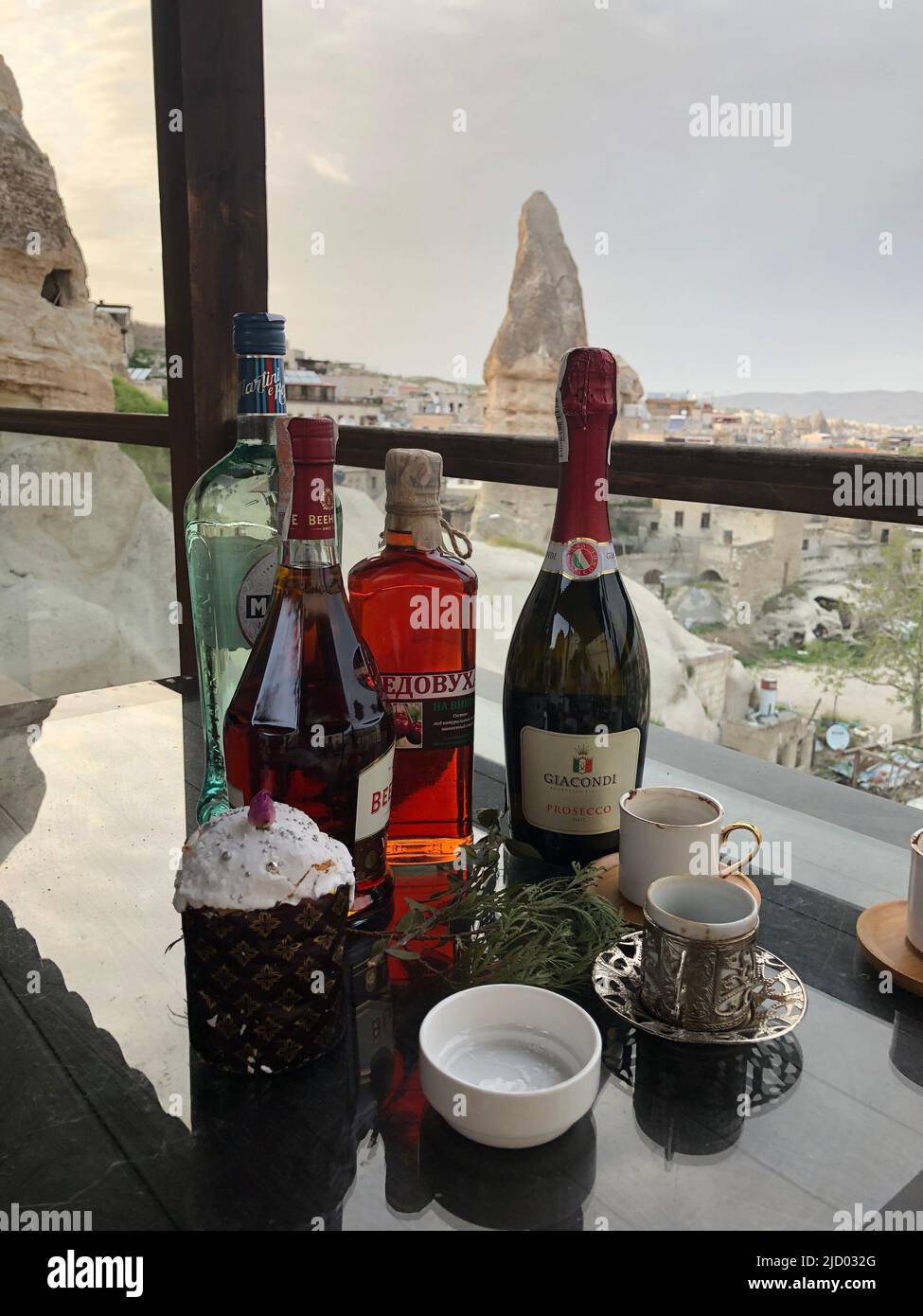 https://c8.alamy.com/comp/2JD032G/cappadocia-turkey-05022021-three-bottles-of-alcoholic-drinks-a-traditional-easter-cake-and-empty-turkish-coffee-cups-2JD032G.jpg