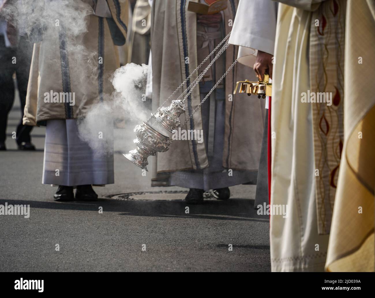 Bamberg, Germany. 16th June, 2022. An altar boy waves a container of incense during the Corpus Christi procession in Bamberg. Credit: Frank Rumpenhorst/dpa/Alamy Live News Stock Photo