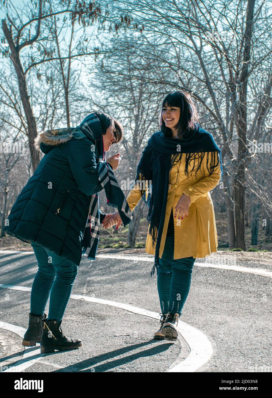 Laughter and happiness of two girls in Iranian hijab with shawls in Tehran, the capital of Iran Stock Photo
