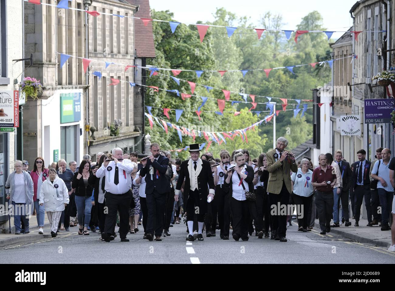 Selkirk, UK. 16.Jun.2022. Selkirk Common Riding 2022. Thursday, The Night afore the Morn. Senior Burgh Officer, Mr Graeme Bell led by the Flute band, preambles the streets starting in the West Port, at 1830hrs, stopping at significant junctions while walking a circuit of the Market Place, High Street, Back Row, Kirk Wynd for the 'Crying of the Burley' and then onwards to the Victoria Halls, for the United Crafts Colour Bussin. At 2000hrs during the proceedings the Selkirk Ex-Royal Burgh Standard Bearers form up in a parade to march to the 'Fletcher Memorial' and lay a wreath and mark respec Stock Photo