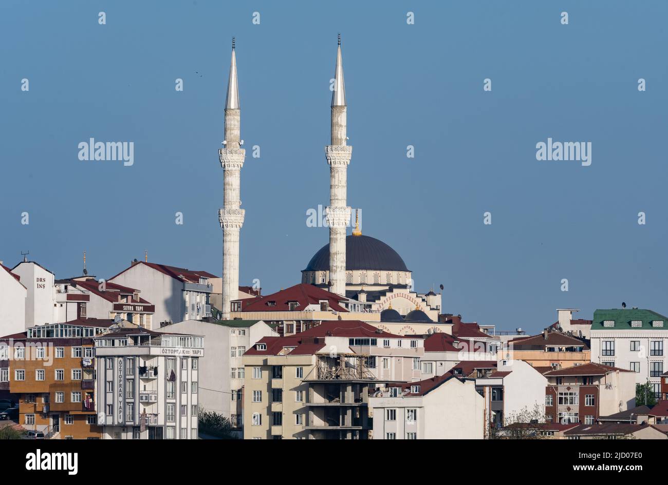 Twin minerets of a mosque in residential area. Istanmbul, Türkiye. Stock Photo