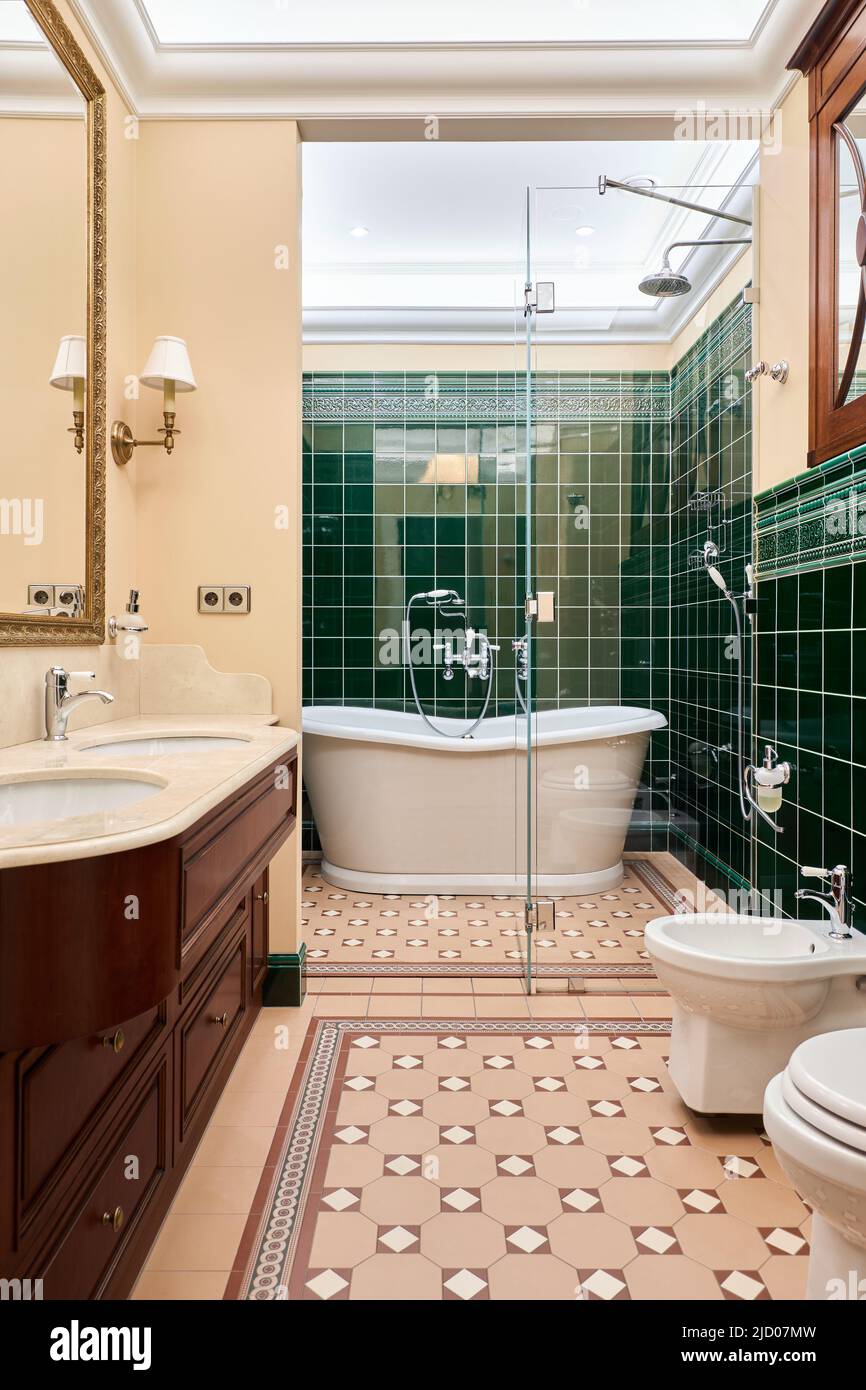 Beautiful cozy luxury bathroom with green tiles Stock Photo - Alamy