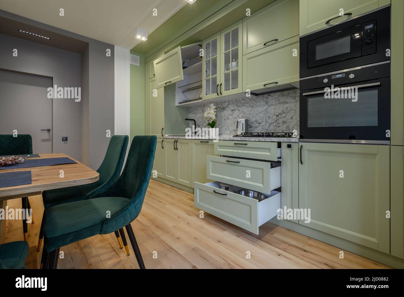 Modern light green luxurious kitchen with dining table Stock Photo - Alamy