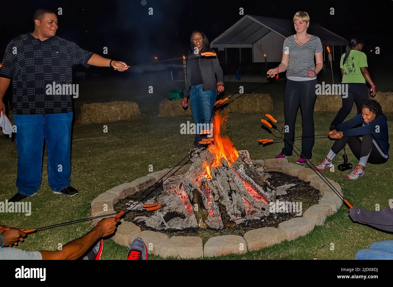 People roast wieners over a bonfire, Sept. 25, 2012, in Caledonia, Mississippi. Stock Photo