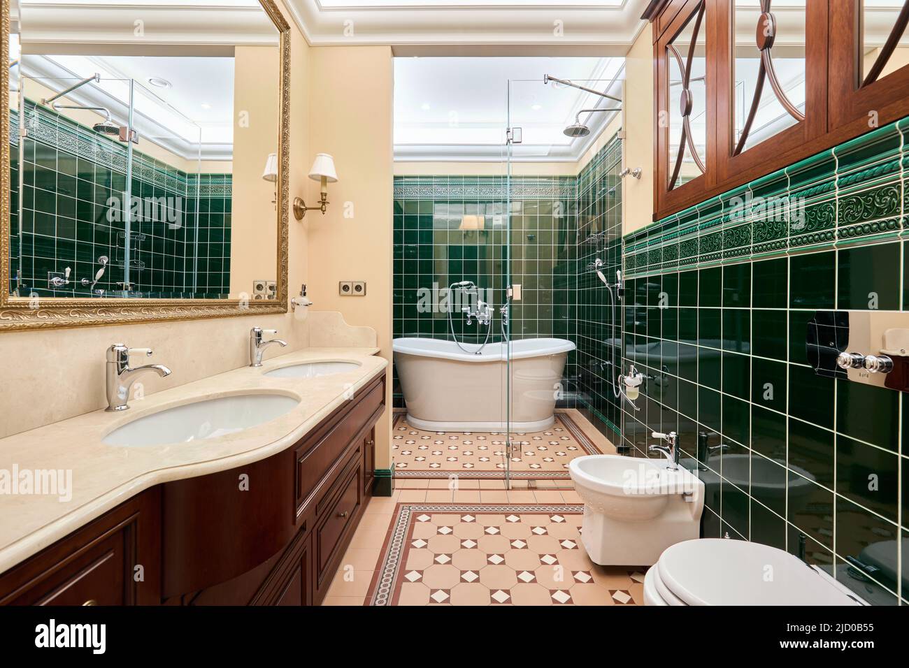 Beautiful cozy luxury bathroom with green tiles Stock Photo - Alamy