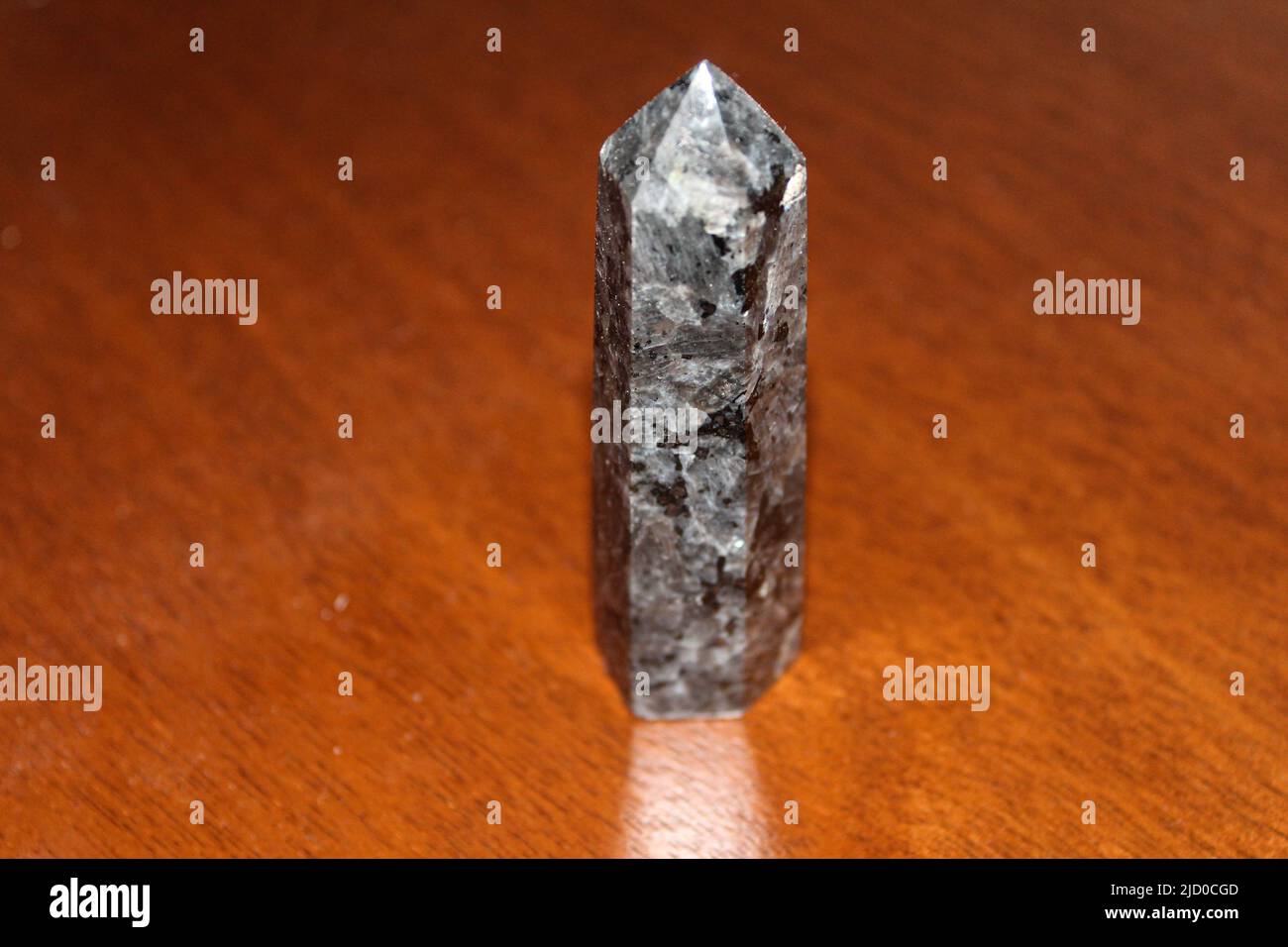 Top view of a polished larvikite point also known as a Larvikite tower crystal. A stone that evokes inner strength by stimulating creativity, wisdom, Stock Photo