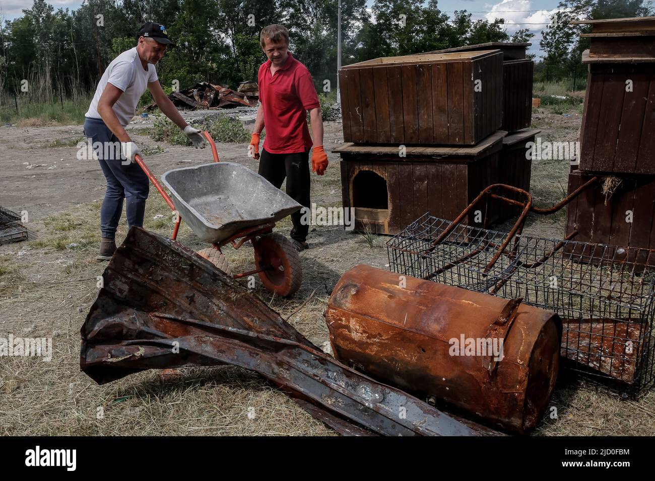 Workers clear the space of a city shelter burned during Russian attack in  Irpin in Kiev Oblast, Ukraine on June 16, 2022. The space will be used by  new animal NGO -
