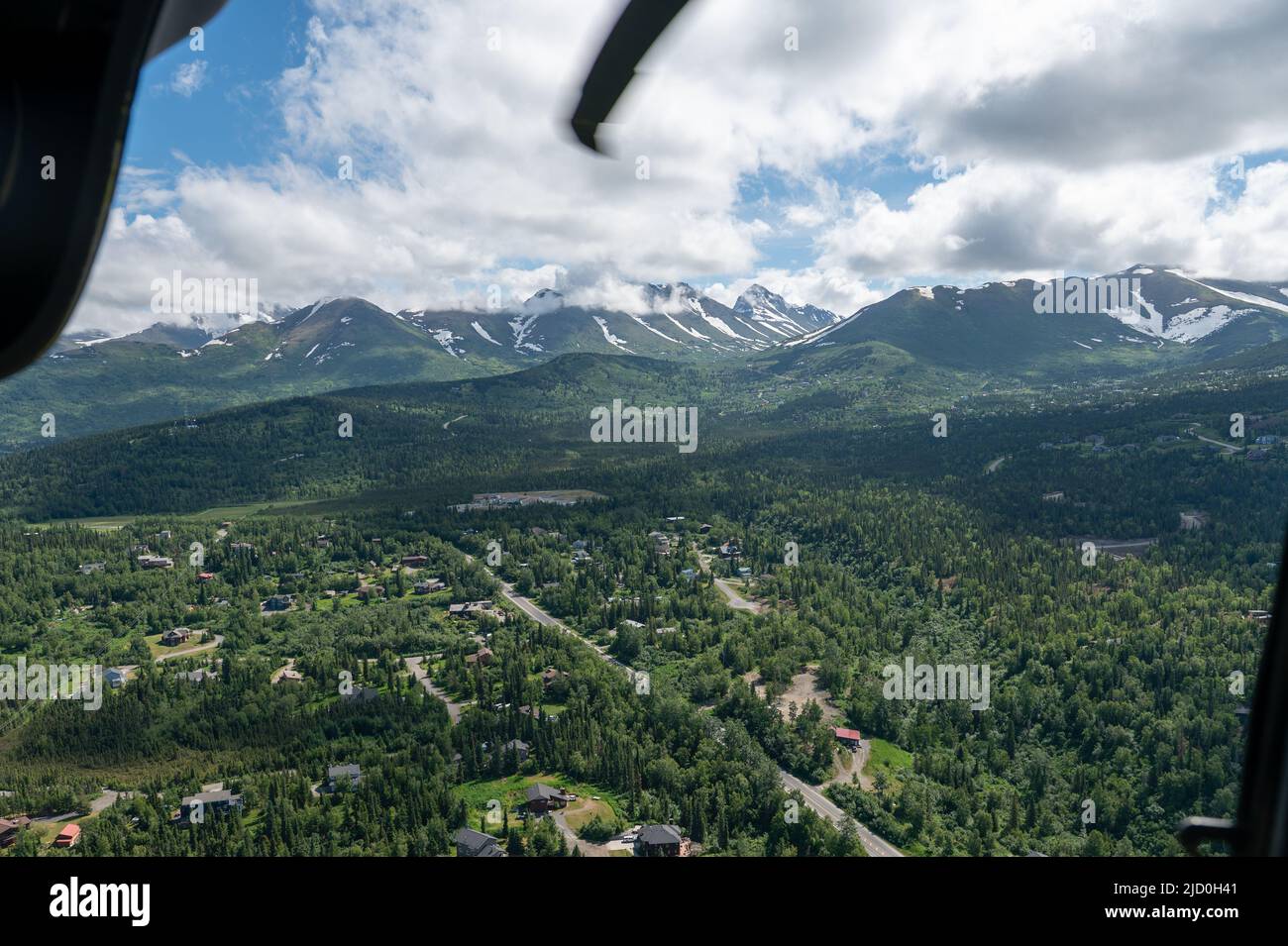 Anchorage, Alaska, can be seen from an HH-60 Pave Hawk assigned to the 210th Rescue Squadron during a Junior ROTC orientation flight at Joint Base Elmendorf-Richardson, Alaska, June 10, 2022. The 210th Rescue Squadron continuously trains to maintain operational readiness for civil search-and-rescue missions as well as contingency operations.   (U.S. Air Force photo by Airman 1st Class Andrew Britten) Stock Photo