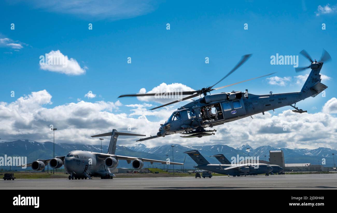A 210th Rescue Squadron HH-60 Pave Hawk takes off for an orientation flight with U.S. Air Force Junior ROTC cadets at Joint Base Elmendorf-Richardson, Alaska, June 10, 2022. Each group of cadets spent an hour in-flight learning about how the unit operates. (U.S. Air Force photo by Airman 1st Class Andrew Britten) Stock Photo