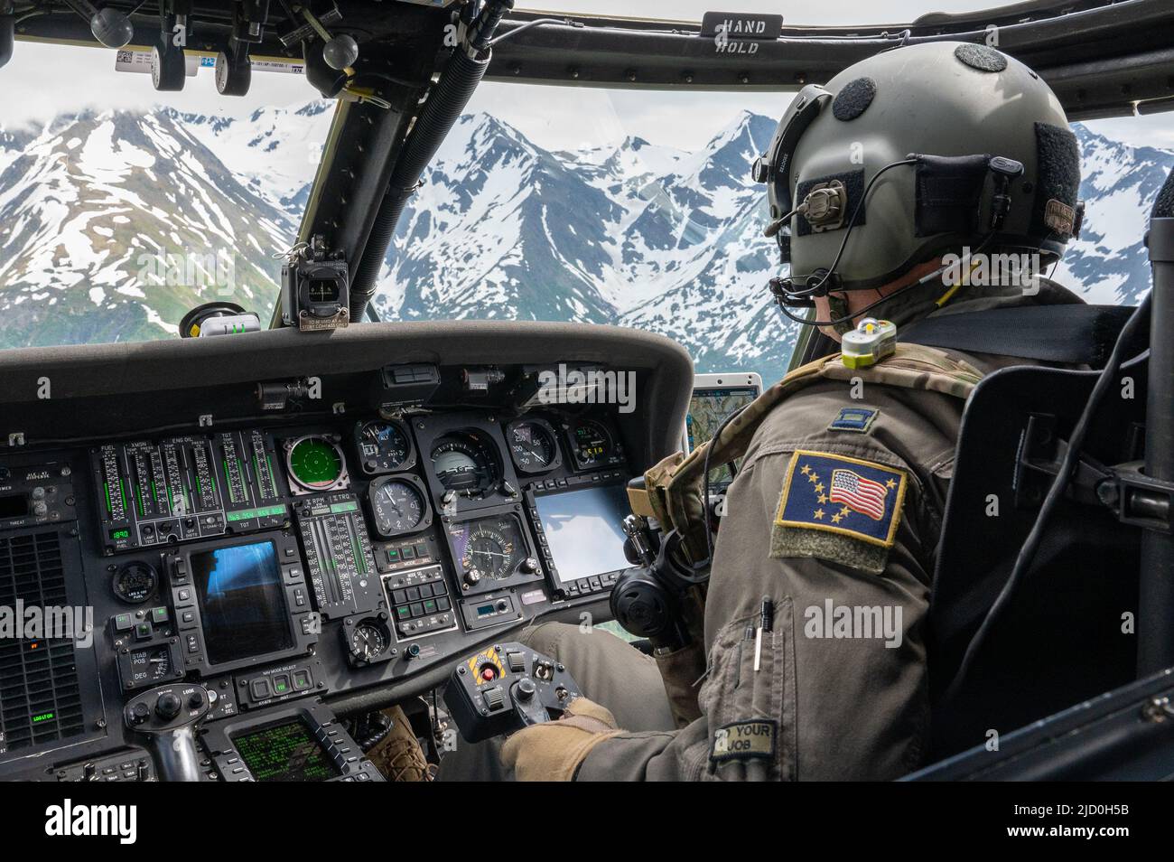 U.S. Air Force Capt. Erin Philips, a 210th Rescue Squadron HH-60 Pave Hawk pilot, flies an orientation flight for U.S. Air Force Junior ROTC cadets over Seward Highway, Alaska, June 10, 2022. Each group of cadets spent an hour in-flight learning about how the unit operates. (U.S. Air Force photo by Airman 1st Class Andrew Britten) Stock Photo