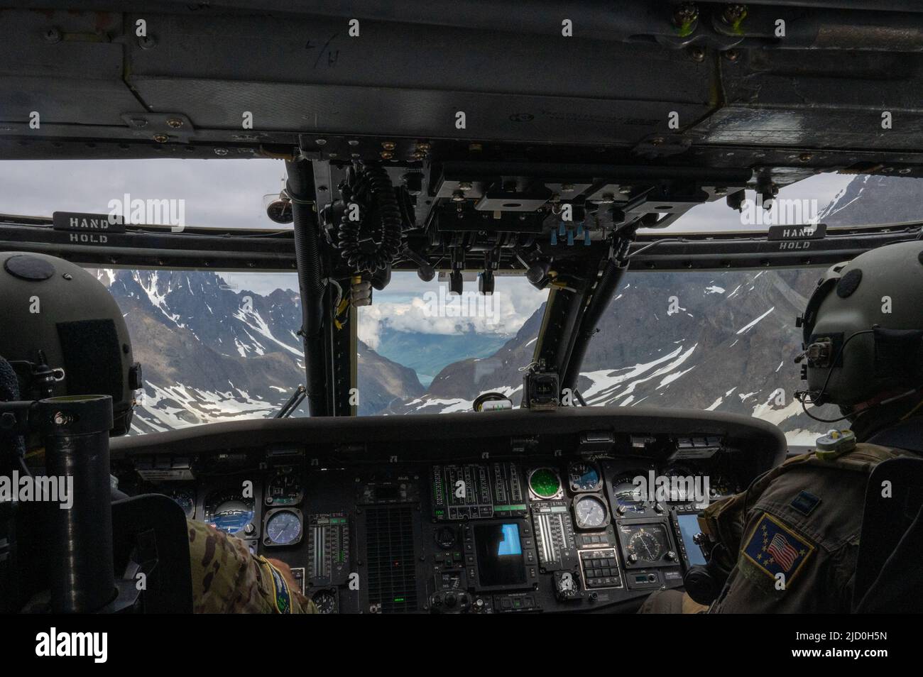 U.S. Air Force Maj. Tyrel Lyon and Capt. Erin Philips, both 210th Rescue Squadron HH-60 Pave Hawk pilots, fly an orientation flight for U.S. Air Force Junior ROTC cadets over Seward Highway, Alaska, June 10, 2022. Each group of cadets spent an hour in-flight learning about how the unit operates. (U.S. Air Force photo by Airman 1st Class Andrew Britten) Stock Photo