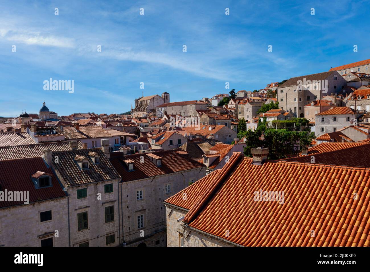 A wispy sky is the backdrop for Dubrovnik's Old Town colorful rooftops Stock Photo