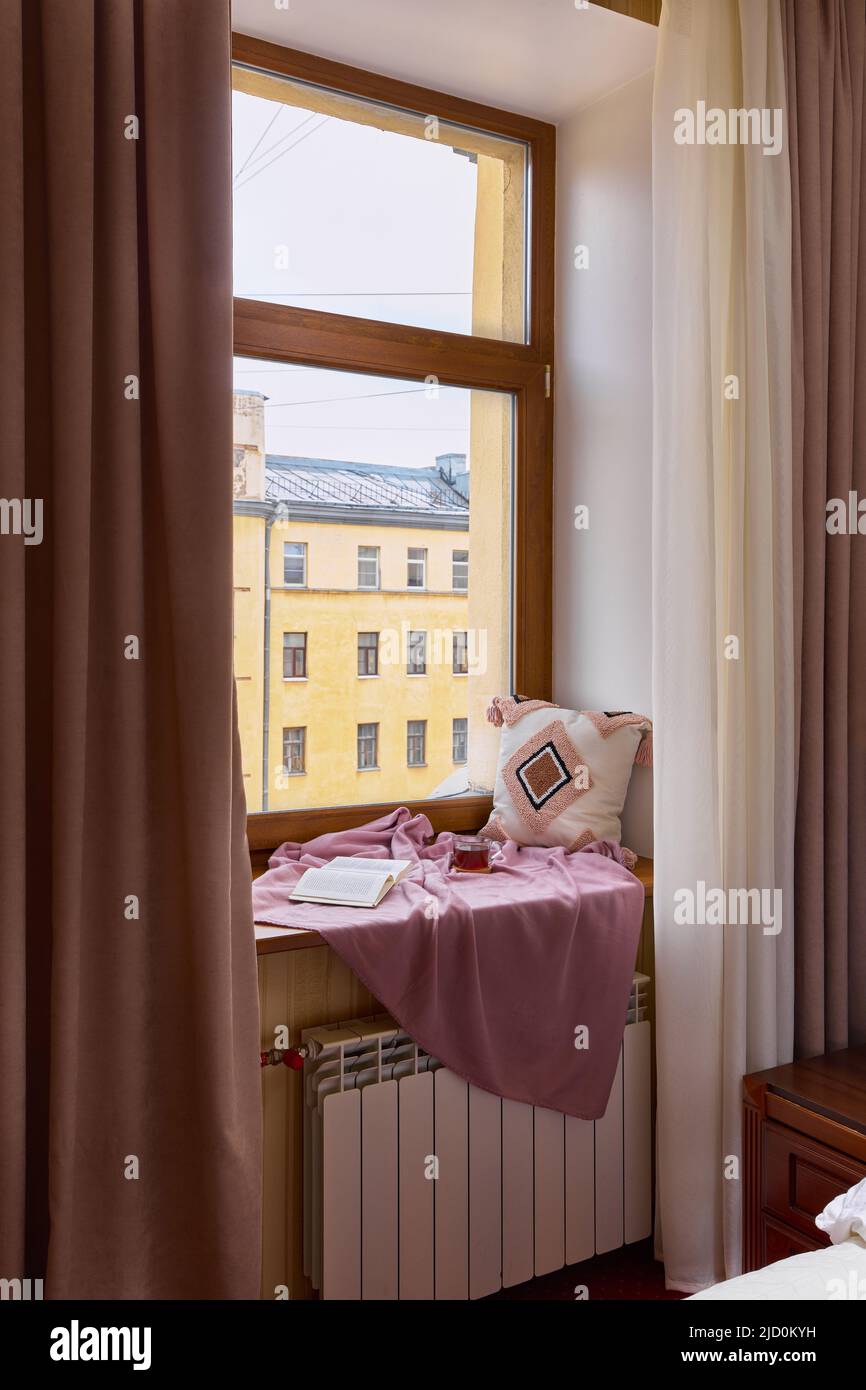 View of Cozy window sill with a blanket and pillow Stock Photo - Alamy