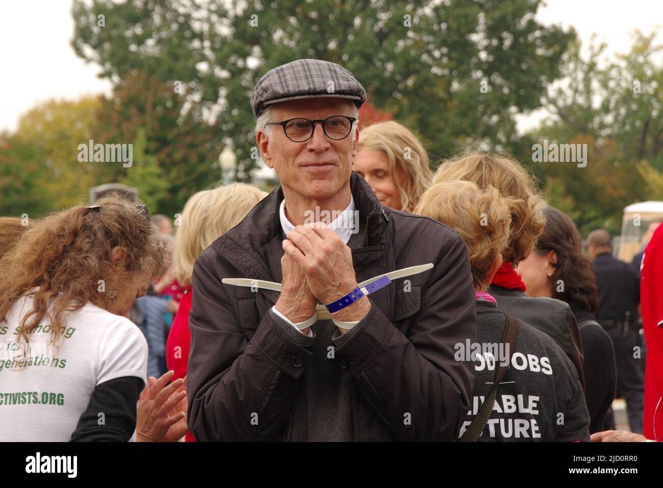 Actor Ted Danson stands under arrest at a Fire Drill Fridays climate change protest near the US Capitol on 25 October 2019. Stock Photo