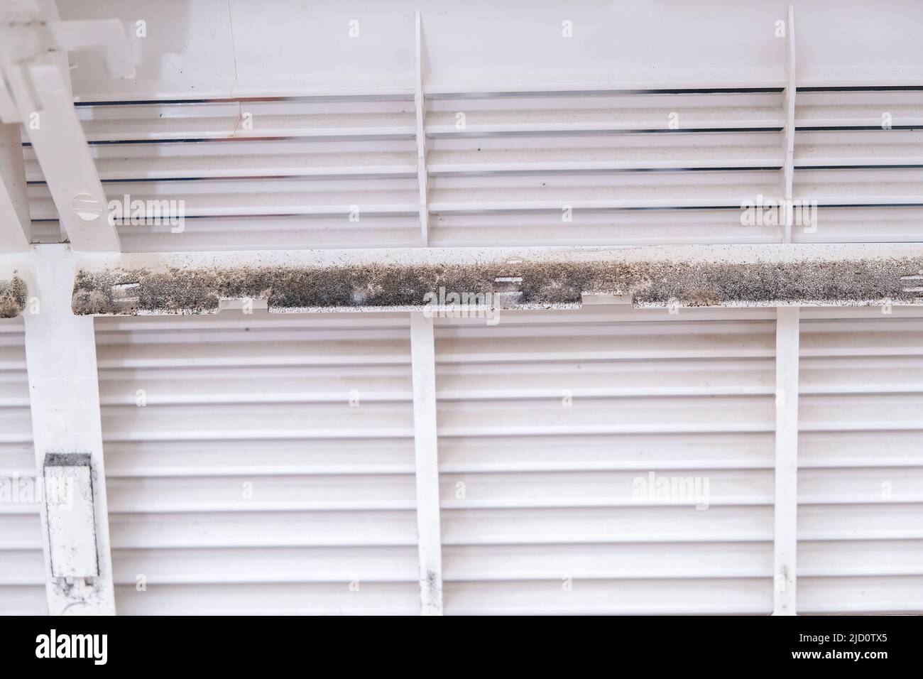 Mold and dust on the air conditioner body. Maintenance and cleaning of