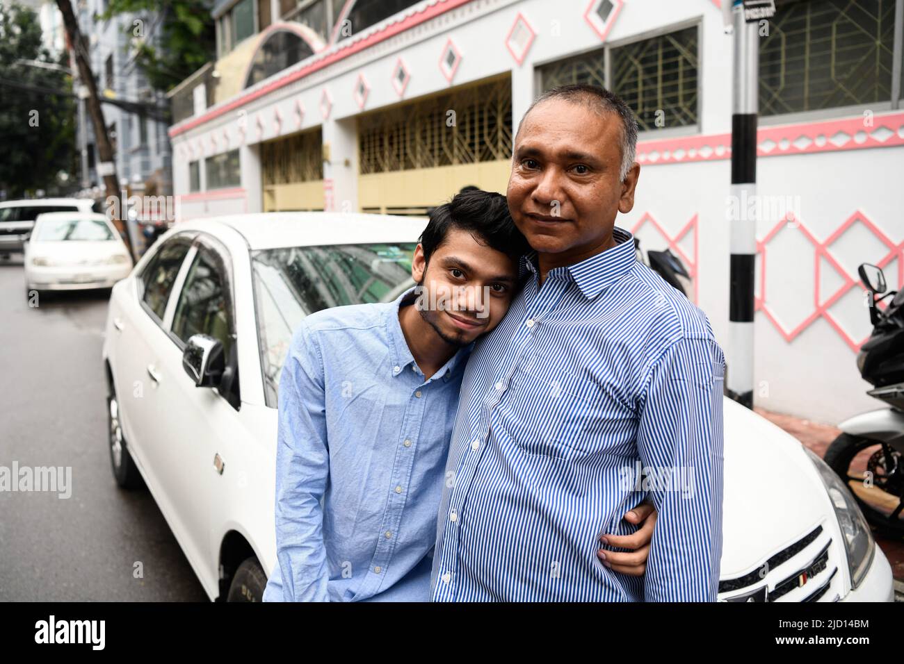 Dhaka, Bangladesh. 16th June, 2022. An Uber driver poses for a portrait with his son in front of his car in Dhaka. The driver said because of lack of income his son had stopped his general education 10 years back, and now his son is able to start his education because driving UBER has earned him a good amount of money. His family is happy now. Credit: SOPA Images Limited/Alamy Live News Stock Photo