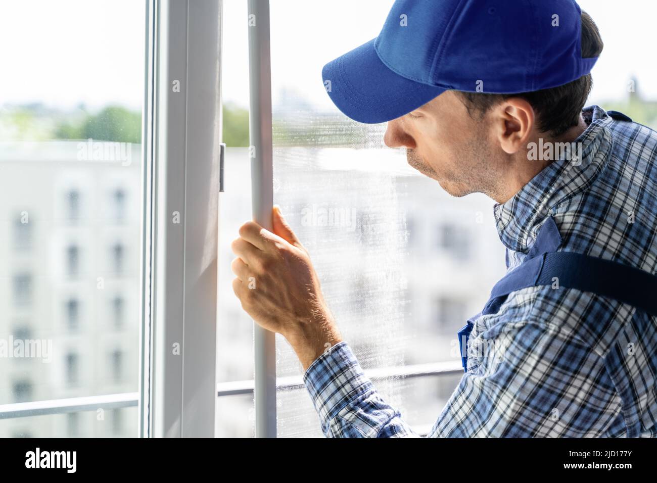 Mosquito Net Frame Install Service. Worker At Home Stock Photo