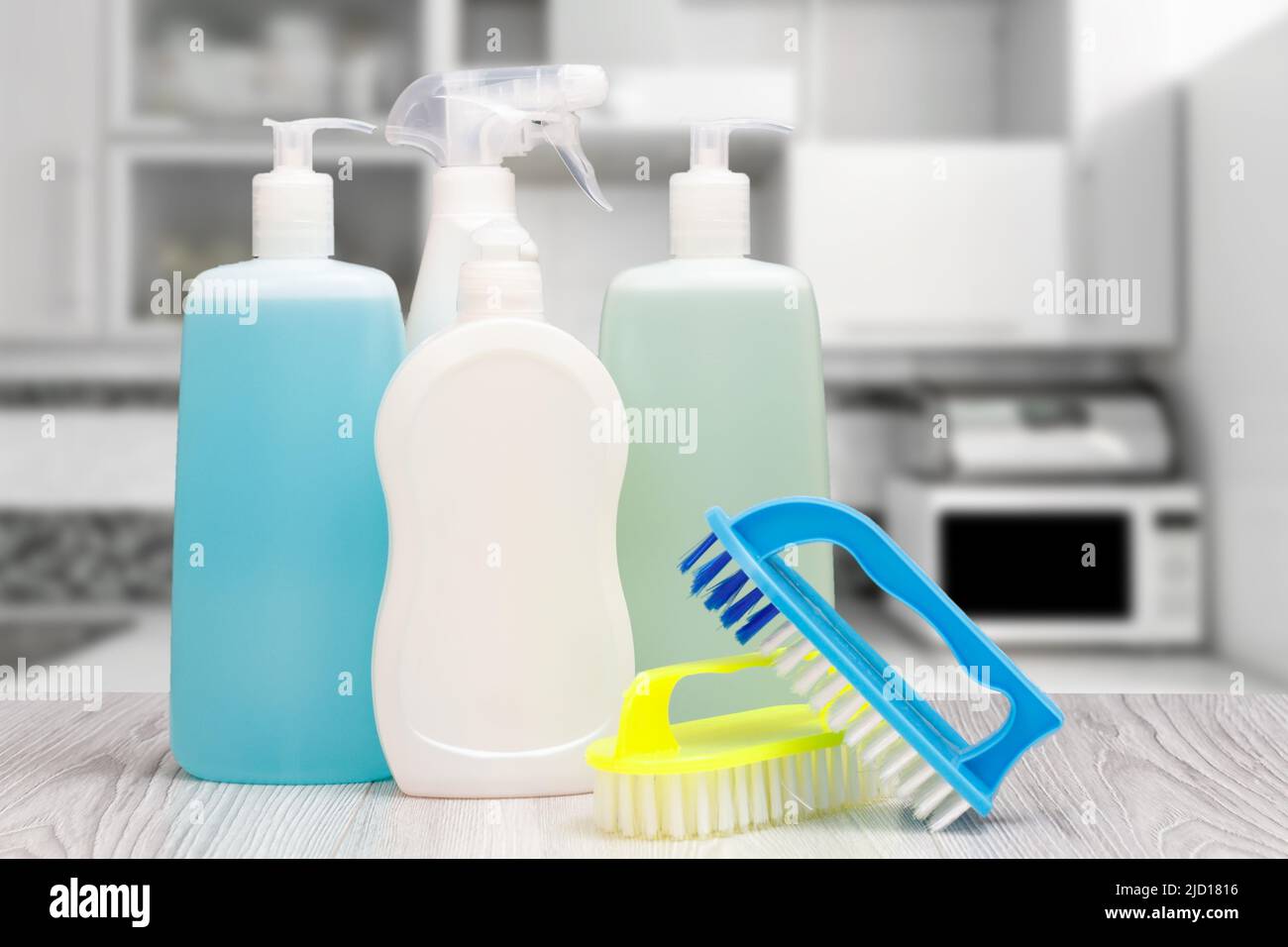 Plastic bottles of dishwashing liquid, glass and tile cleaner