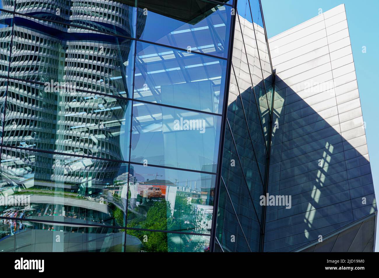 Reflections of the BMW tower and the surroundings in the glass facade of BMW World Munich, Germany, 15.5.22 Stock Photo