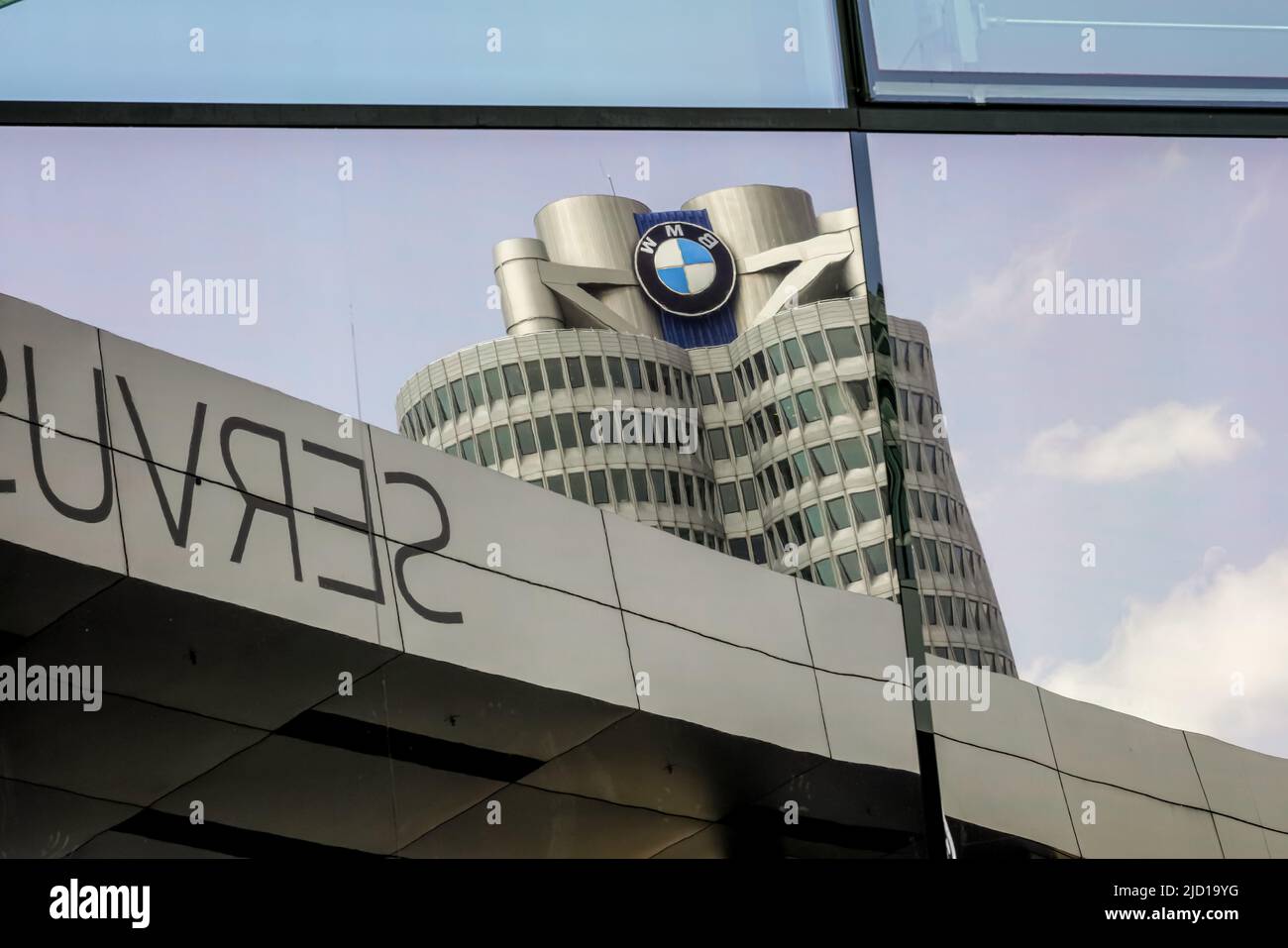 Reflections of the BMW Tower in the glass facade of BMW World Munich, Germany, 9.5.22 Stock Photo