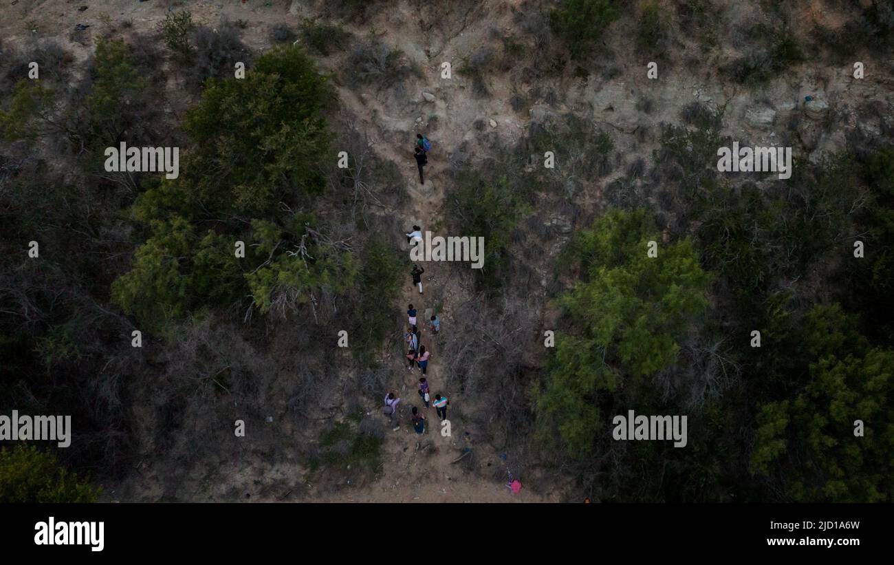 Asylum seeking migrant families climb a steep bank after crossing the Rio Grande river into the U.S. from Mexico in Roma Creek, Texas, U.S., June 16, 2022. Picture taken with a drone on June 16, 2022.  REUTERS/Adrees Latif     TPX IMAGES OF THE DAY Stock Photo
