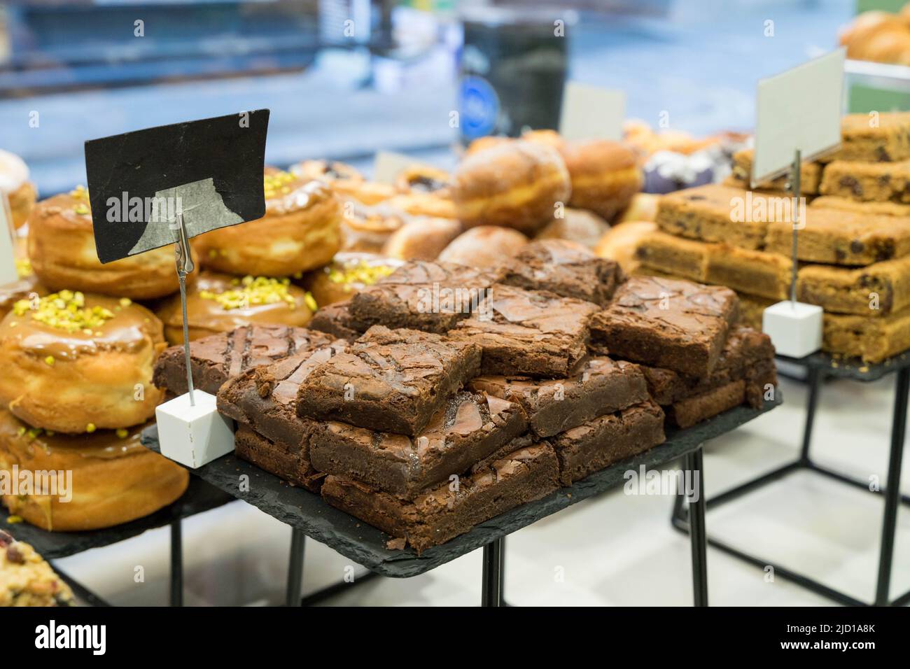 Freshly baked Chocolates brownies stack up for sale on shop window