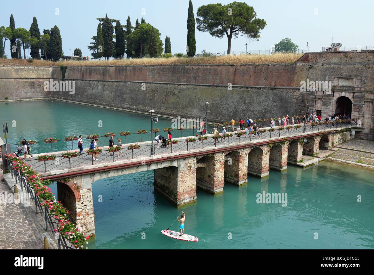 Paddle boarders on the canal in Peschiera del Garda, Italy on sunny day of May, 05, 2022. Stock Photo