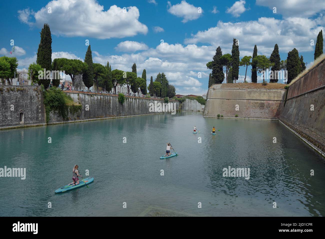 Paddle boarders on the canal in Peschiera del Garda, Italy on sunny day of May, 05, 2022. Stock Photo