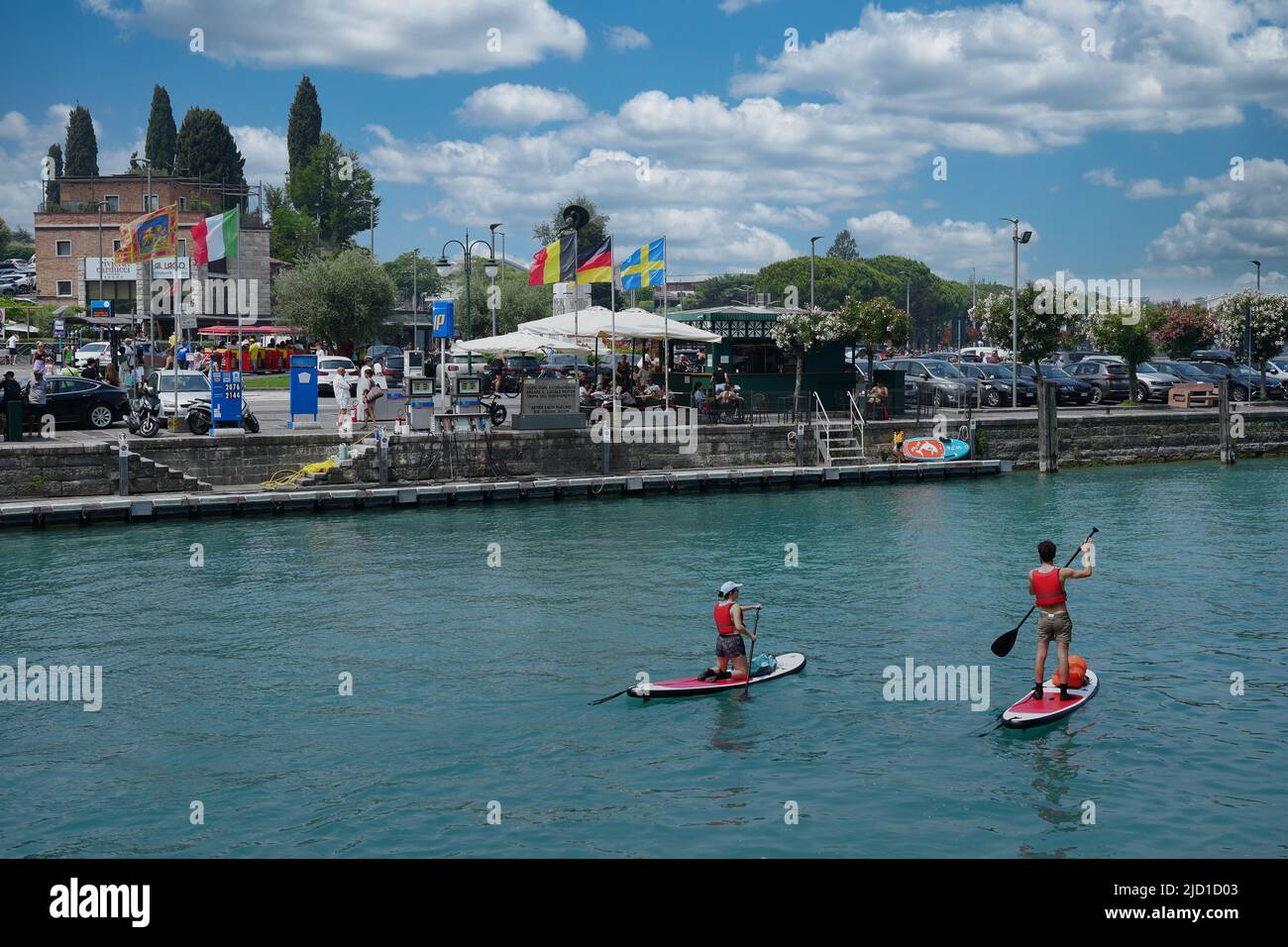 Paddle boarders on the canal in Peschiera del Garda, Italy on sunny day of May, 05, 2022. Stock Photo