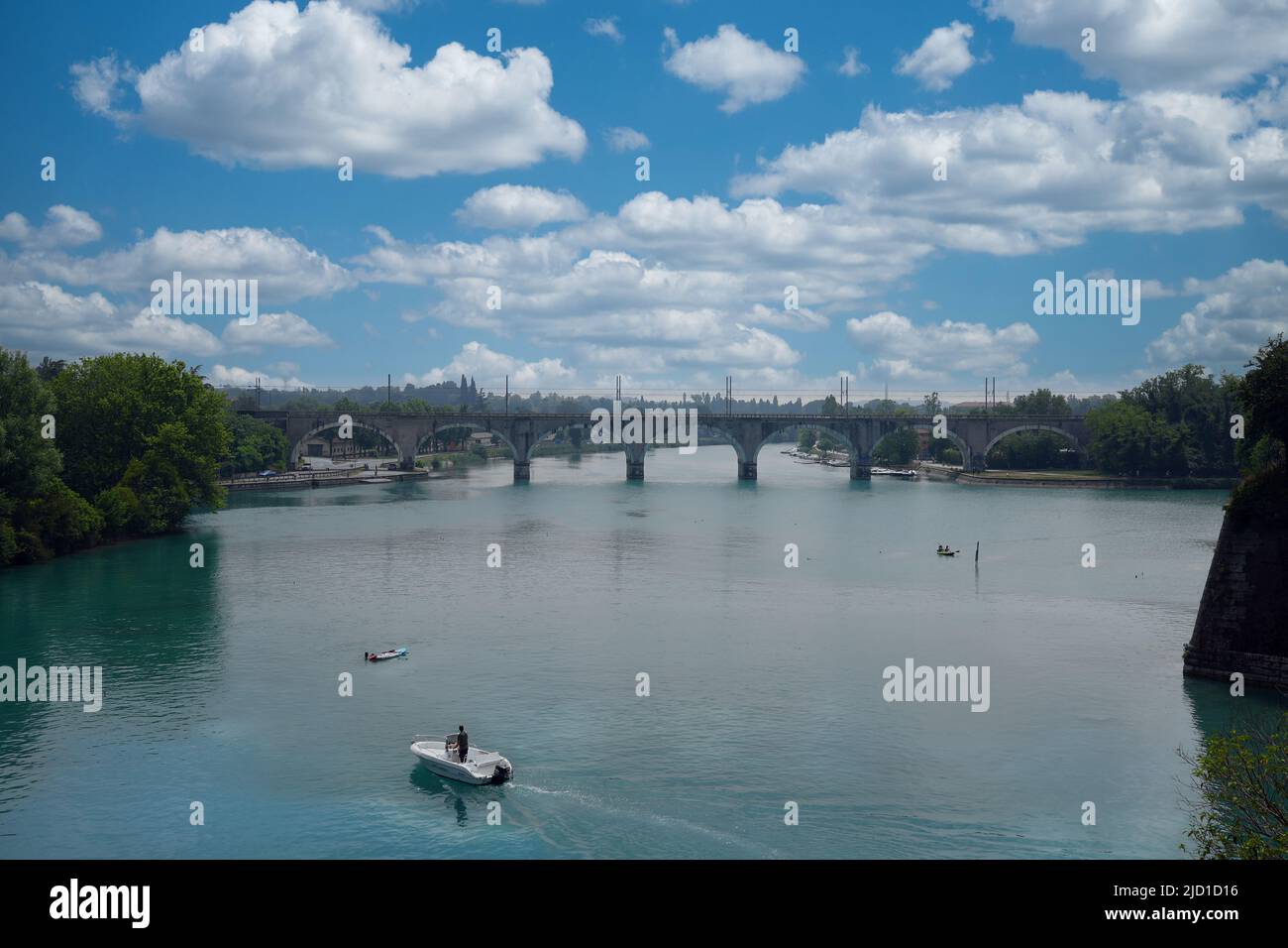 Paddle boarders on the canal in Peschiera del Garda, Italy on sunny day of May, 05, 2022. Stock Photo