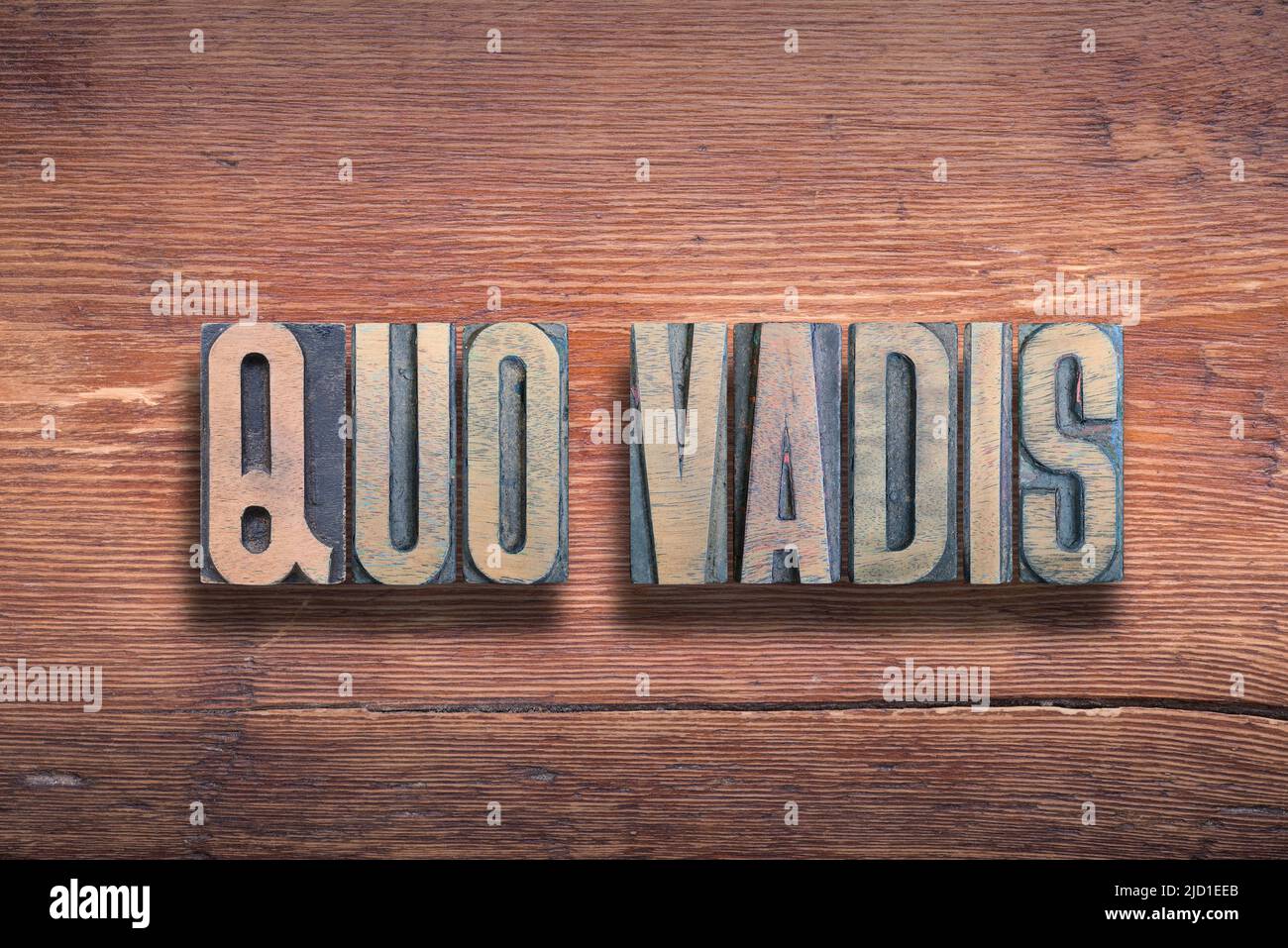 quo vadis ancient Latin saying meaning - where are you going, combined on vintage varnished wooden surface Stock Photo