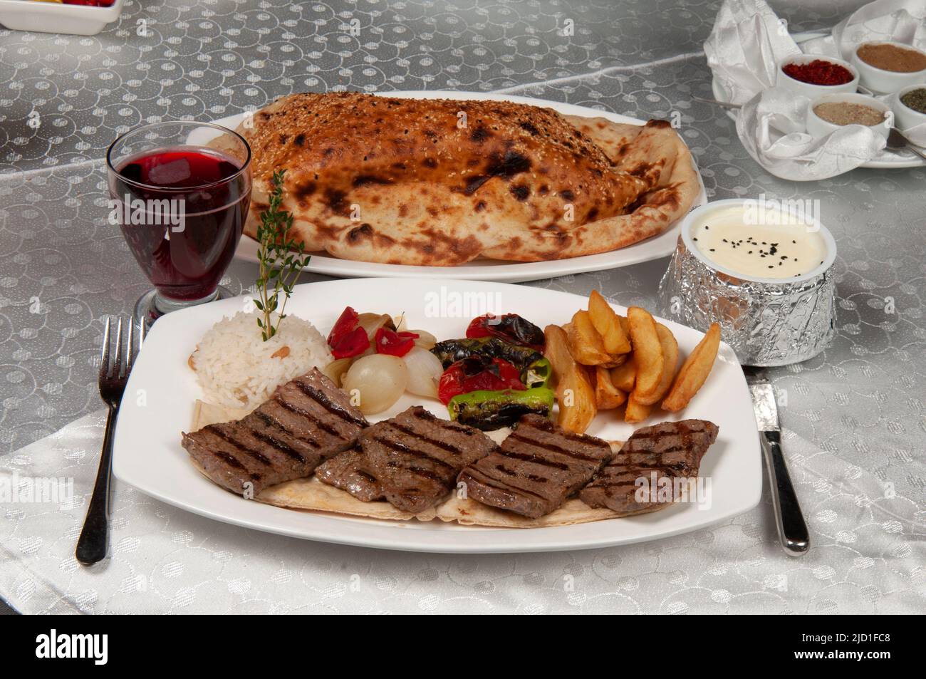 Shish kebab is made of lamb. There is shish kebab, pita bread and fruit