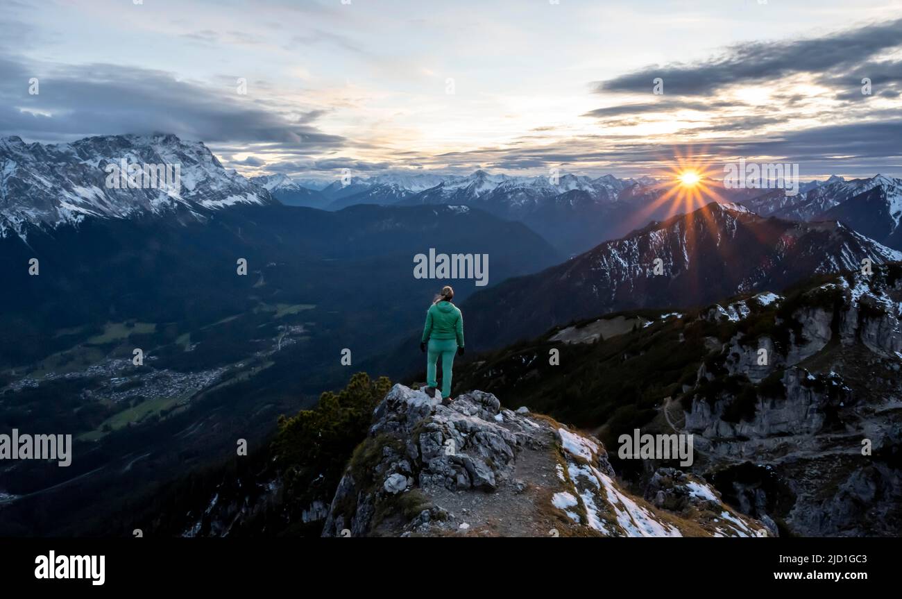 Hiker, sunset, Alpine panorama from the Kramerspitz, Wetterstein Mountains with Zugspitze in the background, Bavaria, Germany Stock Photo