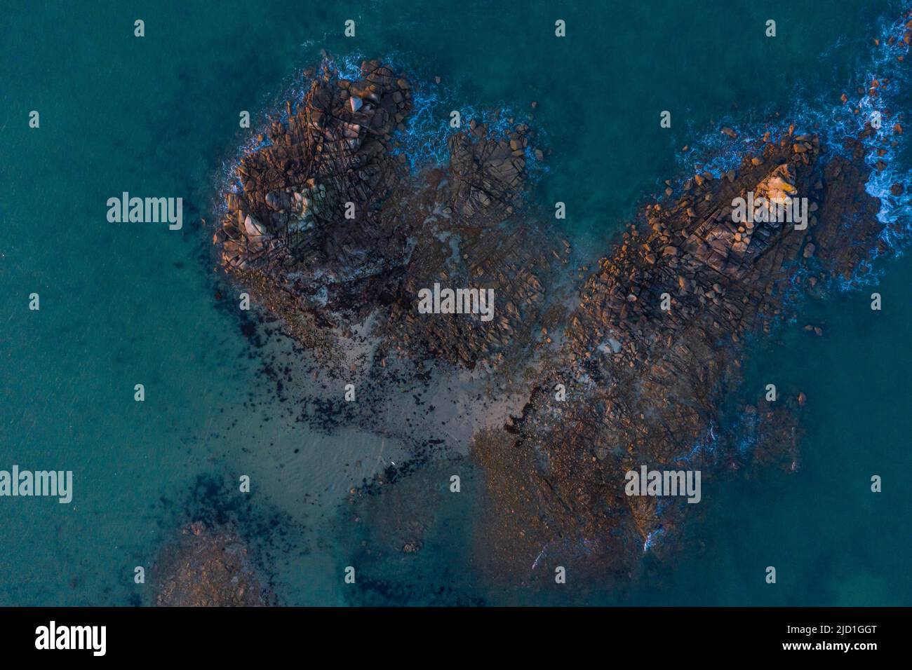 Aerial view of rock formations in the sea in front of the sandy beach Ker Emma shortly in front
