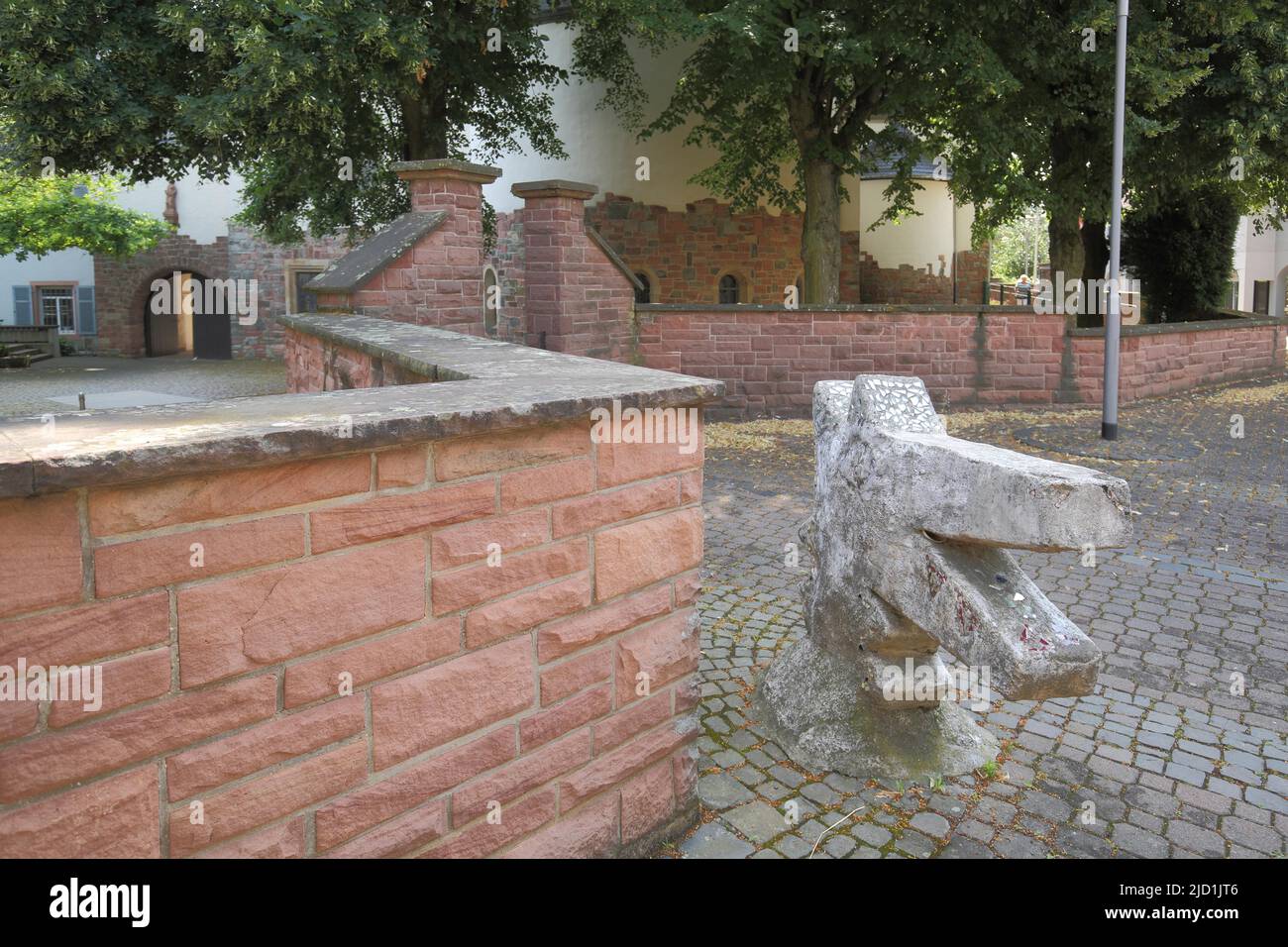 Modern sculpture as an animal head in front of the St. Martinus Church in Hattersheim, Taunus, Hesse, Germany Stock Photo