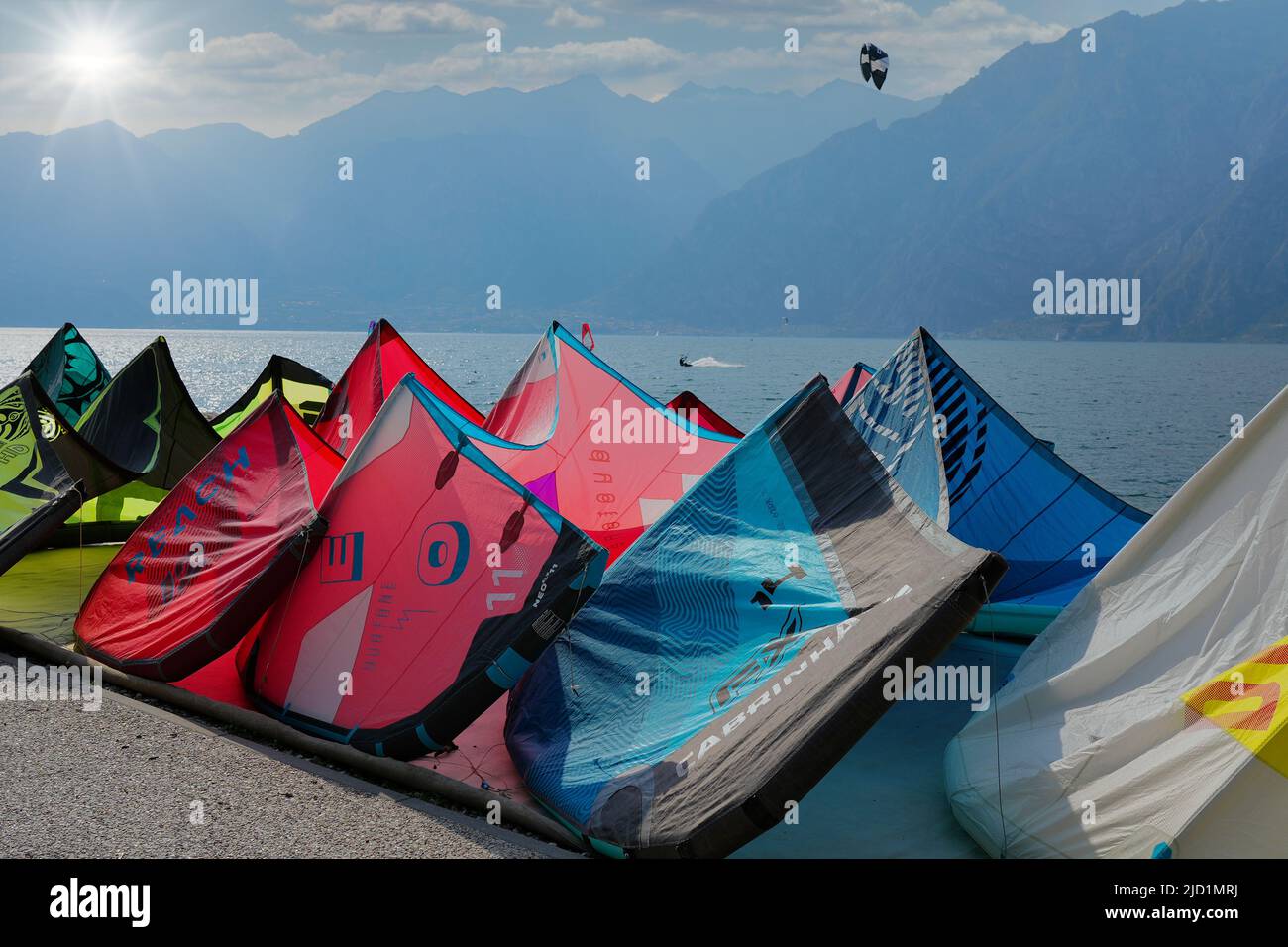 The kitesurfing sails on the shore in Torbole, Garda Lake in Italy Stock Photo